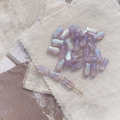 Macro detail of lavender iridescent fish-shaped glass beads for DIY jewelry making - 5# Polarized Purple Fish Bead