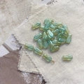 Macro detail of tulip-shaped Czech glass beads in gradient green with iridescent shine - 1# Gradient Green Fish Bead