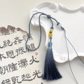 Detail of dark blue ice silk tassel with decorative beads on a ceramic tray - Grey Blue