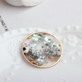 Detail of round gold pendant with rainbow shell flakes and resin inlay on ceramic plate - Oval Style with Iridescent Shell Shards (3#)