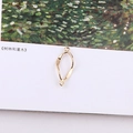Macro shot of twisted gold metal oval link with double loops for DIY jewelry making - Twisted Slender Oval Link Connector (7#)