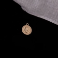Detailed macro view of a vintage gold coin pendant with an embossed portrait and ring - Portrait Relief Round Coin (3#)