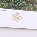 Detailed macro view of gold-plated hollow five-petal flower charms for DIY jewelry making - Five-petal Hollow Flower Pendant with Loop (11#)