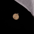 Macro shot of gold Elizabeth II coin pendant with embossed details on black fabric - Elizabeth Portrait (2#)