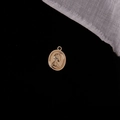 Macro shot of oval vintage gold coin pendant with embossed female head on black background - European Vintage Portrait (9#)