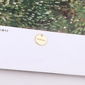 Close-up of a round golden pendant with FASHION engraving for DIY jewelry making - Round Plate Engraved FASHION Charm (18#)