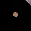 Macro detail of square gold alloy flower pendant with relief design on black background - Matte Gold Rose Square (21#)