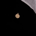 Detailed close-up of a vintage golden coin pendant featuring a 1972 embossed profile - Matte Gold 1972 Portrait (22#)