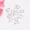 Polished silver spring ring clasps for DIY jewelry necklaces and bracelets on white fabric - 6mm Spring Ring Clasp / Silver