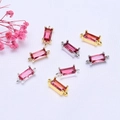 Detailed macro view of 14K gold plated rectangular zircon charms for DIY jewelry making - 14k Gold Color Preserved / Red Zirconia