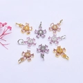 Detail view of 14K gold plated flower charms with pink and purple zircon stones - 14K Gold / Pink Zirconia