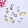 Macro shot of 14K gold plated rectangular zircon connectors with double hanging rings - 14k Gold Color Preserved / White Zirconia