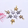Macro detail of 14K gold-plated flower pendants with purple zircon petals for DIY jewelry - Purple Zirconia