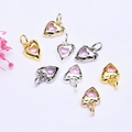 Detail of 14K gold plated heart pendants with pink cubic zirconia and hammered texture - Pink Zirconia