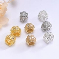 Macro shot of 14K gold hollow filigree beads with sparkling zircons for jewelry making - 18K Gold Plated Color Retention / White Zirconia