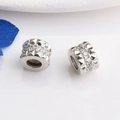Macro shot of 14K gold filled spacer beads with cubic zirconia and geometric textures - White Gold