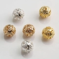 Detailed macro view of 10mm 14K gold-filled hollow beads with intricate scroll patterns - Classical Swirl Pattern (Style No.7) / 18K Gold 10mm
