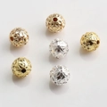 Macro shot of 10mm gold and silver hollow floral spacer beads for jewelry making - Floral Ring Pattern (Style No.16)