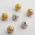 Macro detail of 10mm hollow mesh beads in gold and silver plating for jewelry making - Mesh Weave Texture (Style No.14)