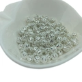 Macro view of silver hollowed geometric metal beads for DIY jewelry making in a bowl - 10mm / Silver (Color Preserving)