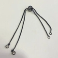Close-up of gunmetal adjustable box chain slide clasp with sparkling zircon accents - Black & Gold