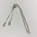 Detail of adjustable silver box chain bracelet with micro-pave round slider and charms - White Gold