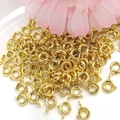 Close-up of gold-filled spring ring clasps for DIY jewelry necklace and bracelet making - Spring Clasp 5.5mm / Gold