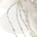 Detail shot of silver rectangular paperclip chain with polished metallic finish - Silver Plated (Color Retention)
