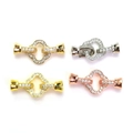Close-up of four-leaf clover jewelry clasps in gold and silver with micro-pave zircons - 18k Gold Color Preserved / Clover