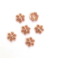 Makroaufnahme von roségoldenen Schneeflocken-Zwischenperlen mit glitzernden Zirkonia-Steinen - 8mm Schneeflocke / Roségold