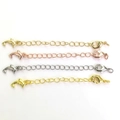 Detail of 14k gold-filled jewelry extension chains with lobster clasps and dolphin charms - Dolphin