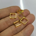 Five small 14k gold-plated square bead frame charms held on a hand for jewelry making - 10mm / 18K Gold
