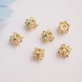 Macro view of 14K gold plated flower bead caps with micro-pave green zircon settings - 14K Gold / Green Zircon