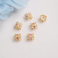 Close-up of 14K gold plated flower bead spacers with inlaid pink zircon for DIY jewelry - 14K Gold / Red Zircon