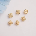 Macro detail of 14K gold plated hollow floral spacer beads with sparkling cubic zirconia - 14K Gold / White Zircon
