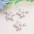 Macro detail of silver maple leaf pendants with shimmering micro-pave cubic zirconia crystals - Platinum Color (White Zirconia Maple)