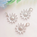 Macro detail of three silver sunflower pendants with inlaid marquise-cut cubic zirconia - Platinum Color (White Zirconia Sunflower)