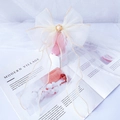 Detailed view of white organza bow hair clip with gold edges and long elegant ribbons - XS / Light Yellow