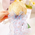 Close-up of a pet straw hat featuring a large light blue peach print ribbon bow - Blue Peach Ribbon Bow Hat