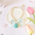 Close-up of pearl pet collar with light green polka dot bow and mint green bell detail - Green Bell Bow