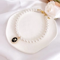 Macro detail of pearl pet necklace with black enamel rose pendant on white silk - XS / Black Rose Necklace