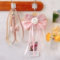 Detail of pink tweed dog harness featuring a silk bow and 3D white camellia flower - Small / Pink Bow Ribbon