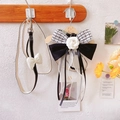 Detail of tweed dog harness with black bow, camellia flower and pearl tassels - Small / Black and White Bow Ribbon