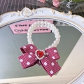 Elegant white pearl pet collar with a red striped bow and heart gemstone accent - Polka Dot Bow