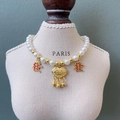 Pet pearl necklace with gold long-life lock and Mahjong Fa pendants on display - Longevity and Wealth Lock