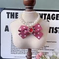 Elegant pet pearl necklace featuring a red polka dot bow and heart gem pendant - Polka Dot Bow