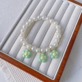Handmade pet necklace featuring white pearls and three delicate light green flower charms - Green Flower