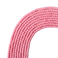 Pink cylindrical polymer clay beads arranged in arcs for DIY jewelry making - Pink