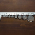 Detailed view of clear glass cabochons in various sizes displayed on a dark wood background - Transparent Glass Cabochon / 30mm
