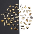 Close-up of golden champagne rhinestones with multi-facet cuts for DIY nail art - Metallic Gold - Irregular